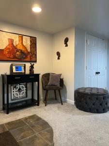 a living room with a couch and a chair at Homestay Basement Falls Church in Falls Church