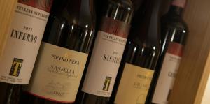 four bottles of wine are lined up on a shelf at Hotel Duc De Rohan in Livigno +79 photos