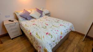 A bed or beds in a room at Skellig View Sunset Cliffs View Apartment