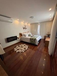 a bedroom with a bed and a television in it at Miradouro São Pedro da Serra in São Pedro da Serra