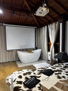 a bathroom with a white tub and a large window at Miradouro São Pedro da Serra in São Pedro da Serra +57 photos