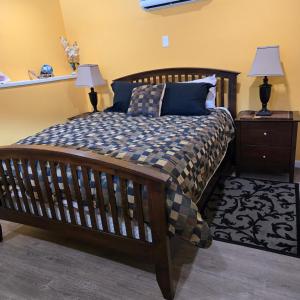 a bedroom with a large wooden bed with two lamps at Ocean's Edge in Port Alice