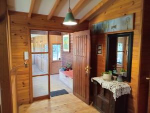 a room with a hallway with a table and a door at Raki Bed and Breakfast Hostel in Trape +7 photos