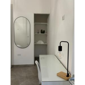 a room with a white table and a mirror at Salento Apartment in Brindisi
