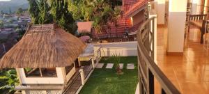 a balcony of a house with a grass roof at Bajawa-Roo Hotel in Bajawa