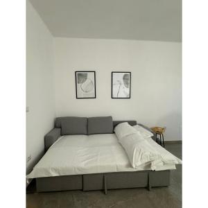a bed in a room with two pictures on the wall at Salento Apartment in Brindisi