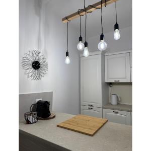 a kitchen with a wooden cutting board on a counter at Salento Apartment in Brindisi