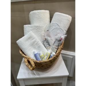 a basket filled with toothbrushes and towels on a table at Salento Apartment in Brindisi