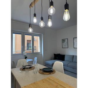 a kitchen and living room with a table and a couch at Salento Apartment in Brindisi