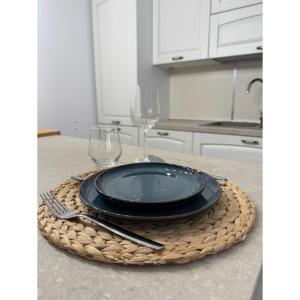 a black plate and two wine glasses on a table at Salento Apartment in Brindisi