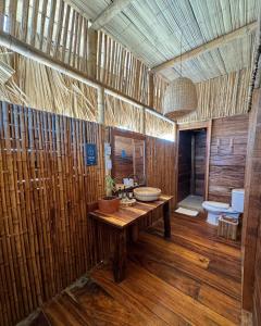 a bathroom with a sink and a toilet at Palaa Mayapo Ecolodge in Mayapo