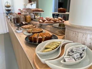 a buffet with different types of food on a table at Hotel Capital in Cupra Marittima +76 photos