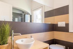 a bathroom with a sink and a toilet at Orizzonte Blu 103 in Liscia di Vacca +26 photos