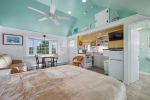 a large bedroom with a bed and a kitchen at Seaside Cottages - Cottage 16 - Beach Cottage in South Yarmouth
