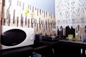 a microwave sitting on a counter in a kitchen at Sunshine Place S5 in Lagos