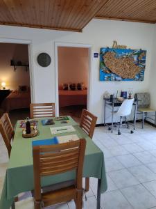 a dining room with a green table and chairs at Marques House in Machico