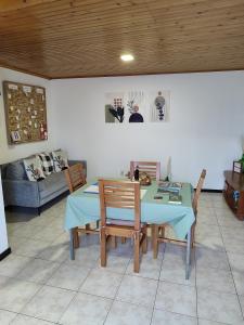 a dining room table and chairs in a living room at Marques House in Machico
