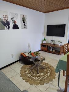 a living room with a couch and a tv at Marques House in Machico