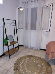 a living room with a table and a rug on the floor at Marques House in Machico