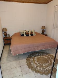a bedroom with a bed with two shoes on it at Marques House in Machico