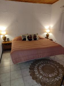 a bedroom with a large bed with two shoes on it at Marques House in Machico