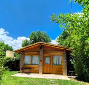 a small cabin in the middle of some trees at Aimara Casas de alquiler in Mina Clavero +4 photos