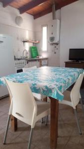 a dining room table with a blue and white table cloth at Aimara Casas de alquiler in Mina Clavero