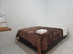 a bed with two rolled towels on top of it at KaVal in Jardin
