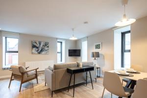 a living room with a couch and a table at 3rd Floor Stylish 2-Bed Apartment in Drogheda