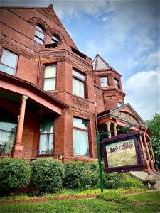 a large brick building with a sign in front of it at Vineyard Mansion B&B in Saint Joseph