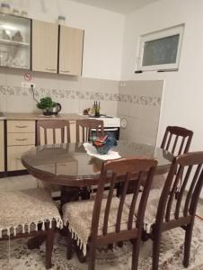 a kitchen with a wooden table and chairs and a table and chairsktop at Perfect Place 3 - Djenovici in Đenovići +18 photos