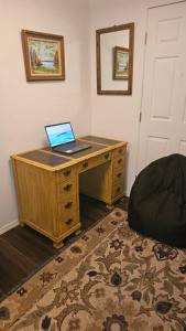 a desk with a laptop computer on top of it at The Secret Hideaway in Oakhurst