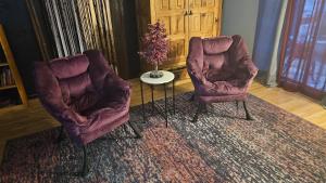 two chairs and a table in a living room at The Secret Hideaway in Oakhurst +2 photos