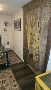 a living room with a large painting on the wall at The Secret Hideaway in Oakhurst +1 photo