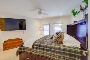 a bedroom with a bed with a plaid blanket at Ski, Hike & More! Couple's Getaway in Beech Mtn in Beech Mountain