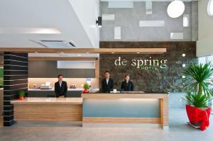 a group of people standing at a reception desk at De Spring Hotel in Kuantan