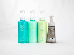 a group of four bottles of soap and liquids at Hotel Route-Inn Uozu in Uozu