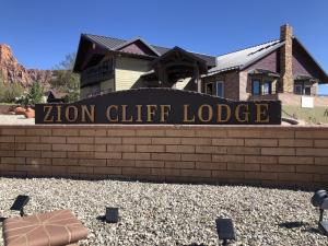 a sign for a zion cliff lodge in front of a building at Zion Cliff Lodge in Hildale