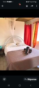 a picture of a bedroom with a bed at Bungalow Créole in Sainte-Rose