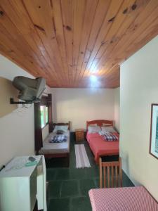 a living room with a bed and a couch at Espaço Riacho in Nova Friburgo