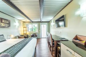 a room with a bed and a desk and a television at Orbost Motel in Orbost
