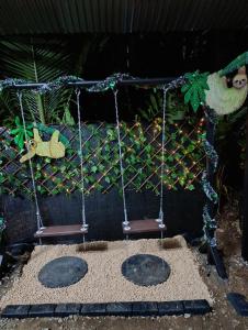 a swing set with two chairs in a playground at Chava Camping Rio Celeste in Rio Celeste