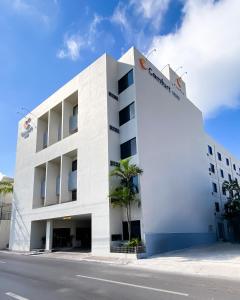 a white building with a sign on the side of it at Comfort Inn Tampico in Tampico