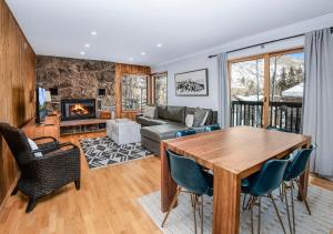 a living room with a table and chairs and a fireplace at 4479 Timber Falls 2001 in Vail