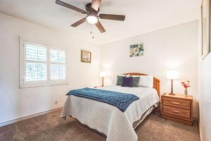 a bedroom with a bed and a ceiling fan at Family Oasis in Anaheim