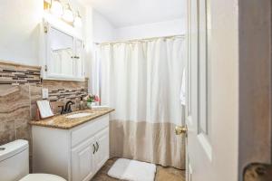 a bathroom with a sink and a toilet and a shower at Family Oasis in Anaheim +17 photos