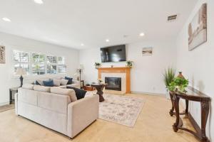a living room with a couch and a fireplace at Family Oasis in Anaheim