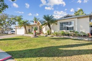 a house with a yard with palm trees at Family Oasis in Anaheim