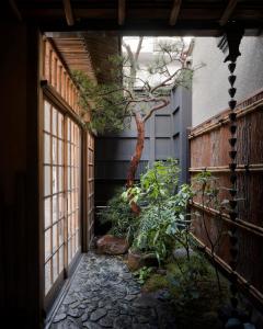 a courtyard with a tree in a building at Trunk House in Tokyo