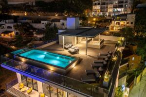 a swimming pool on the roof of a building at night at 605 Tower Los Cabos in Cabo San Lucas